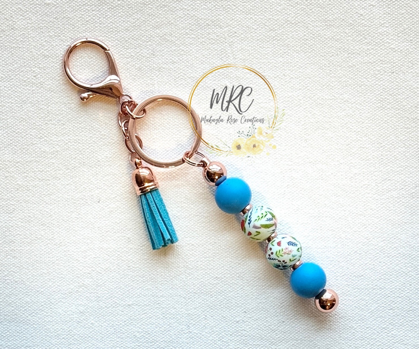 Pop of Floral Beaded Rose Gold Keychain Bar w/Blue Tassel